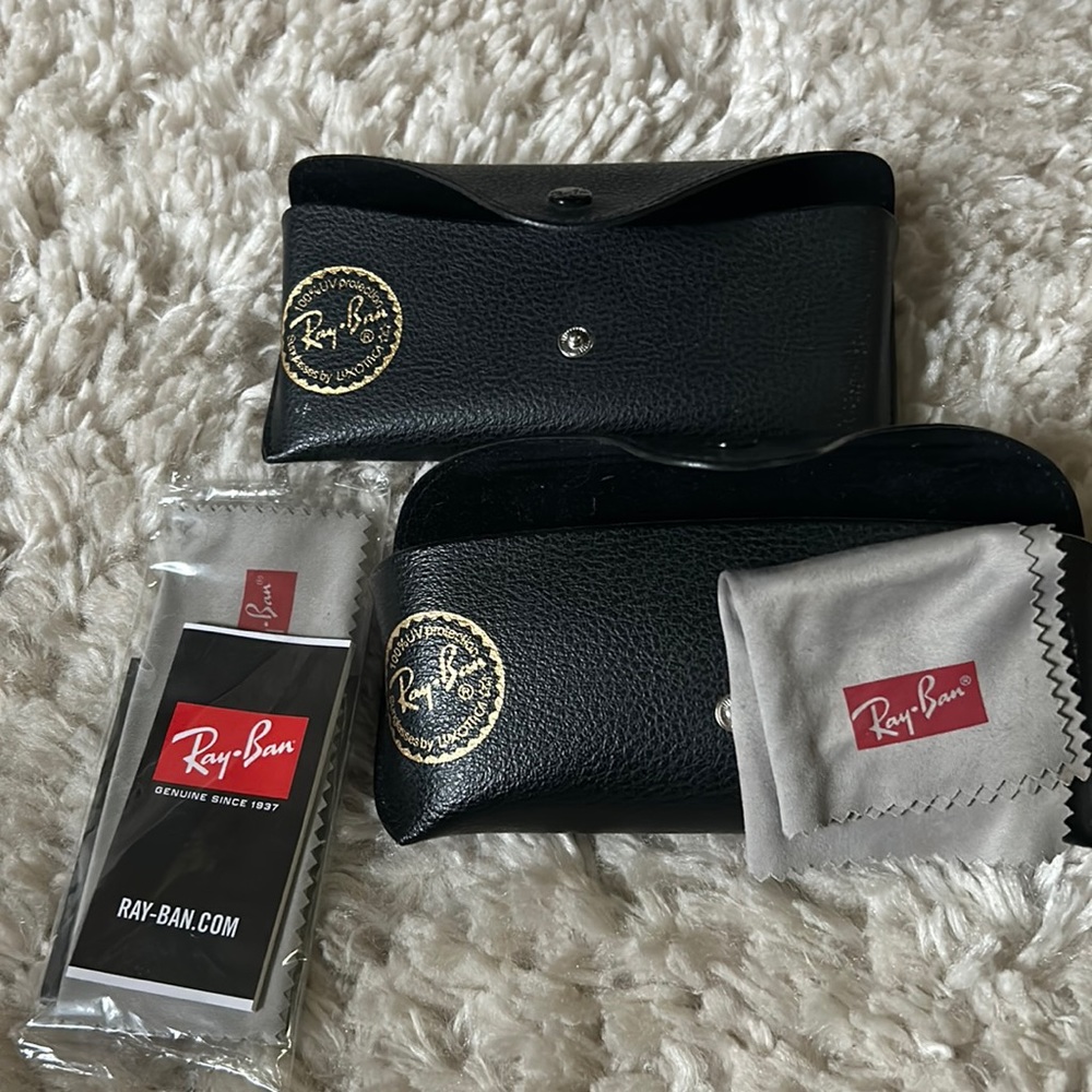 Two ray ban sunglasses cases and cleaning cloths